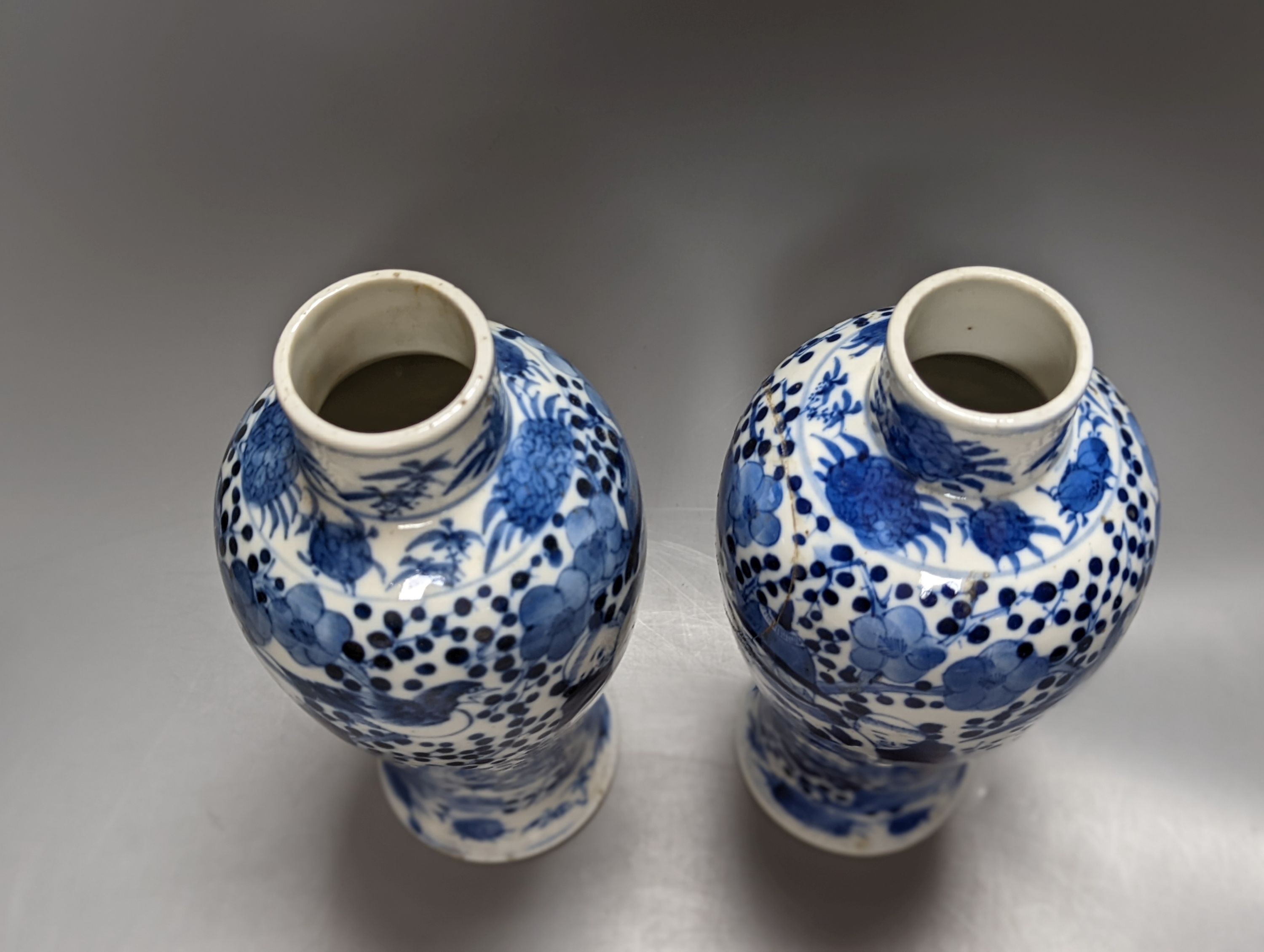 A pair of 19th century Chinese blue and white vases, a prunus vase and cover and a similar jar (4), pair of vases 24 cms high.